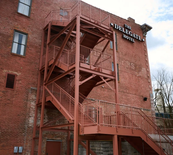Outdoor steel staircase for external traffic flow and evacuation routes.